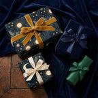 Celestial wrapping paper with gold sun and moon patterns and luxury velvet ribbons by Wrapped Studios.