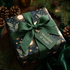 Celestial Christmas wrapping paper with a forest green ribbon and gold star pattern, by Wrapped Studios.