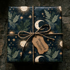 Mystical celestial wrapping paper with a gold sun and moon pattern on a gift box. By Wrapped Studios.