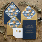 Celestial wedding invitation suite with navy and gold sun and moon envelope liners by Wrapped Studios.