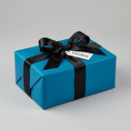 Cerulean blue gift wrap with black satin ribbon and bow for birthday, holiday, or wedding presents.