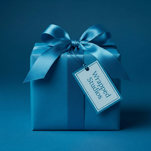 Elegant solid blue gift wrapping paper with satin ribbon bow and tag, perfect for birthdays or special occasions.