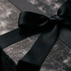 Luxury chalkboard math wrapping paper with a black satin ribbon bow by Wrapped Studios.