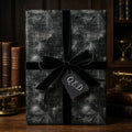 Dark academia math wrapping paper with blackboard equations, black velvet ribbon, and Q.E.D. tag by Wrapped Studios.