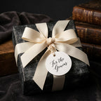Vintage chalkboard wrapping paper with a cream ribbon and 'For the Genius' tag by Wrapped Studios.