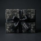 Luxury black wrapping paper with math and science chalkboard formulas, a satin bow by Wrapped Studios.