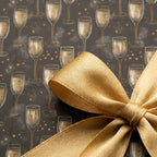 Champagne wrapping paper with gold satin bow, luxury New Year's Eve gift wrap by Wrapped Studios.