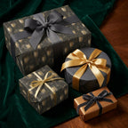 Elegant black and gold champagne glass wrapping paper on luxury holiday gifts by Wrapped Studios.