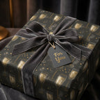 Luxury black and gold champagne gift wrap with a grey velvet bow for New Year's by Wrapped Studios.