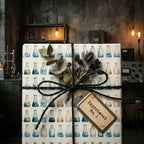 Science beaker wrapping paper with chemistry flask pattern and black twine by Wrapped Studios.