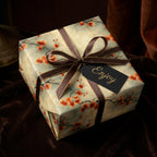 Elegant floral gift wrap with brown ribbon and "Enjoy" tag. Perfect birthday wrapping paper.