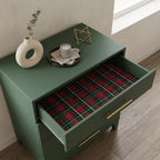 Red and green plaid Christmas wrapping paper lining a dresser drawer, by Wrapped Studios.