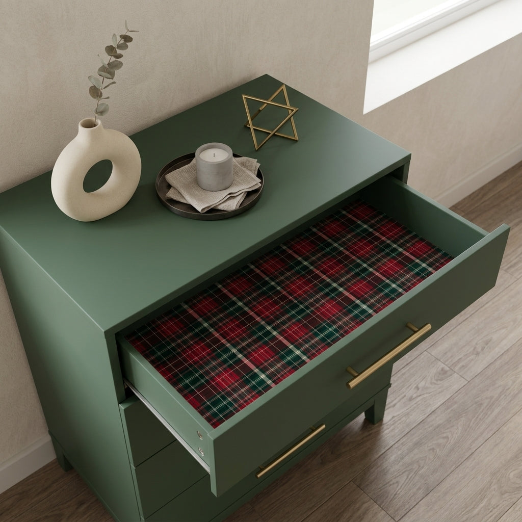 Red and green plaid Christmas wrapping paper lining a dresser drawer, by Wrapped Studios.
