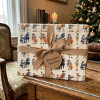 Vintage classical music gift wrap with beige ribbon by Wrapped Studios in a cozy Christmas setting.