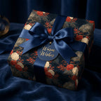 Luxury navy floral wrapping paper with a satin bow and holiday gift tag by Wrapped Studios.