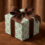 Sage green vintage wrapping paper with a luxury brown ribbon bow on a gift box by Wrapped Studios.
