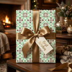 Sage green luxury Christmas wrapping paper by Wrapped Studios on a holiday gift with a gold satin bow.