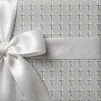 Elegant baptism wrapping paper with a white cross pattern and satin bow by Wrapped Studios.