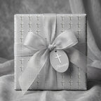 Elegant baptism wrapping paper with crosses, a silver ribbon, and blessings tag by Wrapped Studios.