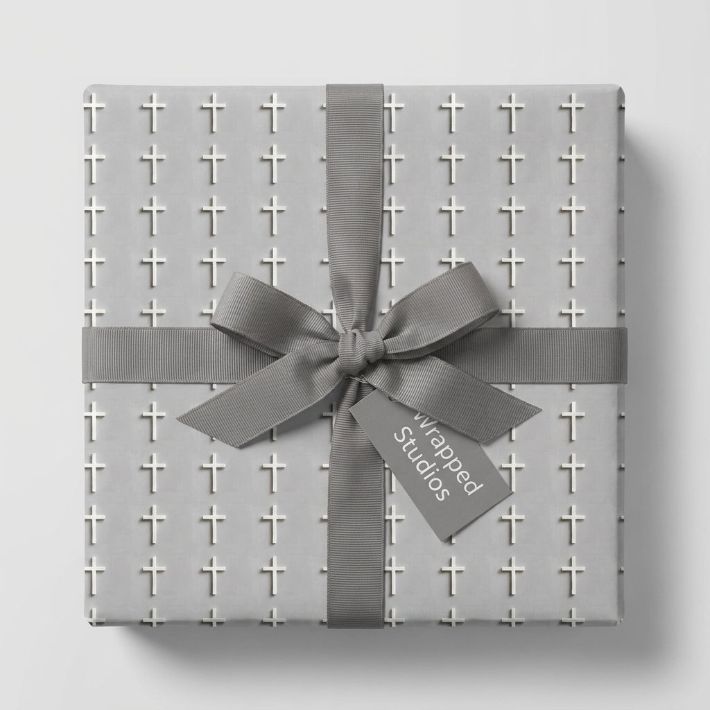 Elegant baptism wrapping paper with a white cross pattern and grey ribbon by Wrapped Studios.