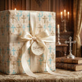 Elegant baptism wrapping paper with cross pattern, satin bow, and Blessings tag by Wrapped Studios.