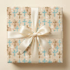 Baptism wrapping paper with blue and brown cross pattern and cream satin bow by Wrapped Studios.