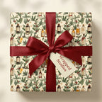 Vintage apothecary Christmas wrapping paper with a red satin bow, by Wrapped Studios.