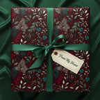 Burgundy floral wrapping paper with green ribbon and gift tag, perfect for holiday or birthday gifts.