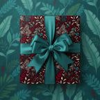 Burgundy floral wrapping paper on gift with teal ribbon bow.