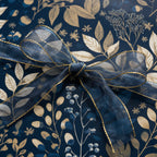 Elegant floral wrapping paper in navy and gold, finished with a sheer blue ribbon.