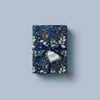 Navy and gold floral wrapping paper on a present with a blue ribbon and tag.
