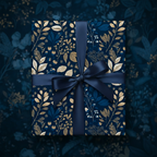 Navy floral wrapping paper on a rectangular gift box with matching satin ribbon.