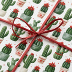 Festive cactus Christmas wrapping paper with a red ribbon bow, holiday gift wrap by Wrapped Studios.