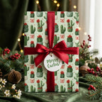 Cactus Christmas wrapping paper with a red satin bow and 'Merry Cactus' tag by Wrapped Studios.