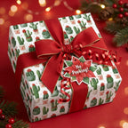 Playful cactus Christmas wrapping paper with a red bow and holiday gift tag by Wrapped Studios.