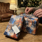 Watercolor city scene Christmas gift wrap tied with silver cord; "For You" tag.