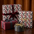 Luxury botanical wrapping paper with elegant burgundy velvet bows on gift boxes by Wrapped Studios.