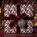Luxury Christmas wrapping paper with botanical print and burgundy velvet ribbon by Wrapped Studios.