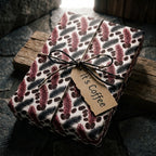 Rustic coffee wrapping paper on a twine-tied gift box with a tag by Wrapped Studios.