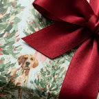 Watercolor dog Christmas wrapping paper with an elegant red satin bow by Wrapped Studios.