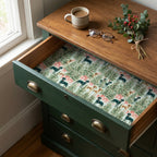Dog Christmas wrapping paper featuring holiday trees lining a green dresser drawer by Wrapped Studios.