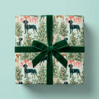 Dog Christmas wrapping paper with watercolor trees and a green velvet bow, by Wrapped Studios.