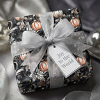 Elegant Christmas gift wrap featuring a silver ribbon, ornament pattern, and a "Joy to the World" tag.