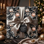 Elegant Christmas gift wrapped in black wrapping paper with gold ornament pattern and satin ribbon from Wrapped Studios.