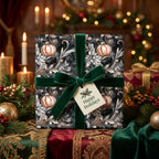 Elegant Christmas gift wrap with ornaments and a dark floral pattern, tied with a dark green velvet ribbon.