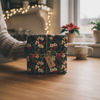 Hand offering floral wrapping paper with twine bow and "For You" tag, perfect for a birthday or Christmas gift.