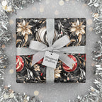 Wrapped Studios luxury gift with black floral wrapping paper, silver ribbon, and holiday ornament design.