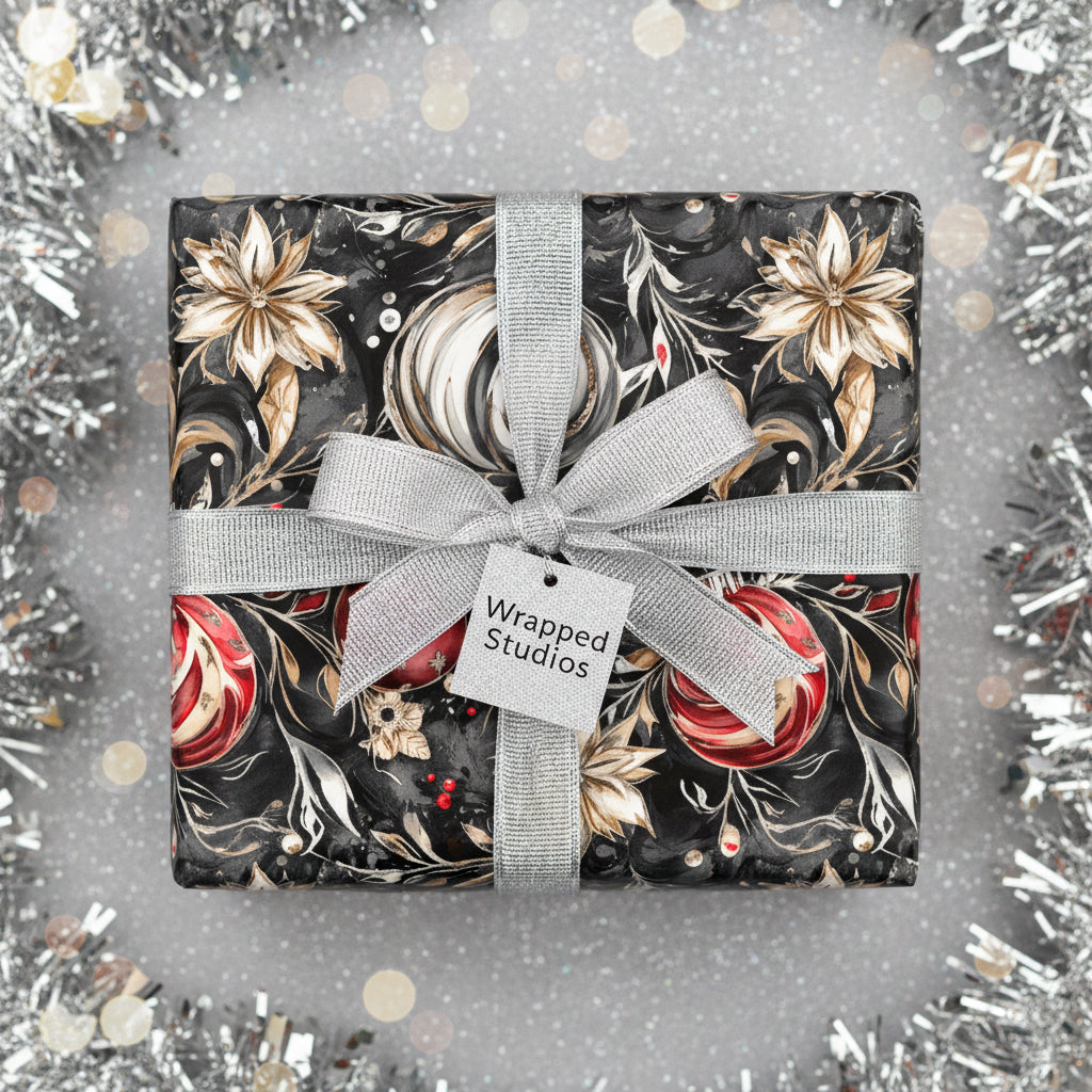 Wrapped Studios luxury gift with black floral wrapping paper, silver ribbon, and holiday ornament design.
