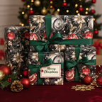 Elegant Christmas gift wrap. Black floral paper with green ribbon and ornament design.