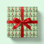 Funny frog Christmas wrapping paper with red ribbon and Santa hats by Wrapped Studios.